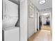 Hallway features washer and dryer, artwork, and leads into the kitchen and living room at 5200 N Ocean Blvd. # 833, Myrtle Beach, SC 29577