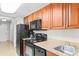 Kitchen with black appliances, wooden cabinets, and countertops at 5200 N Ocean Blvd. # 833, Myrtle Beach, SC 29577