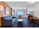 Comfortable living area with sofa, accent chair, coffee table, TV, and balcony access with a view at 5200 N Ocean Blvd. # 833, Myrtle Beach, SC 29577