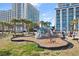Outdoor playground featuring climbing structures and a swing set, located in a resort area at 5200 N Ocean Blvd. # 833, Myrtle Beach, SC 29577