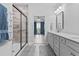 Bathroom featuring double sinks, white cabinets, a glass shower, and a view into the Primary bedroom at 5876 Cremona Dr., Myrtle Beach, SC 29577