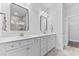 Bathroom featuring double sinks, white cabinets, framed mirrors, and modern lighting at 5876 Cremona Dr., Myrtle Beach, SC 29577