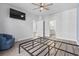 Bright bedroom with a ceiling fan, wood floors, TV, and views into bathroom and additional room at 5876 Cremona Dr., Myrtle Beach, SC 29577