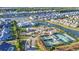 Aerial shot of a beautiful community clubhouse, pond, and tennis courts in a residential neighborhood at 5876 Cremona Dr., Myrtle Beach, SC 29577