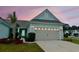 Inviting one-story home with a well-manicured lawn, complemented by a charming palm tree and light-blue siding at 5876 Cremona Dr., Myrtle Beach, SC 29577