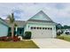 Inviting one-story home with a well-manicured lawn, complemented by a charming palm tree and light-blue siding at 5876 Cremona Dr., Myrtle Beach, SC 29577