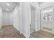 Bright hallway showcasing modern flooring, white trim, and doors leading to other rooms in the home at 5876 Cremona Dr., Myrtle Beach, SC 29577