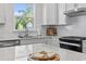 Bright kitchen with a window view, features white cabinets and subway tile backsplash at 5876 Cremona Dr., Myrtle Beach, SC 29577
