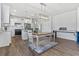 Open concept kitchen and dining area with white cabinets, stainless appliances, and modern lighting at 5876 Cremona Dr., Myrtle Beach, SC 29577