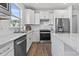 Modern kitchen featuring white cabinets, stainless steel appliances, and granite countertops at 5876 Cremona Dr., Myrtle Beach, SC 29577