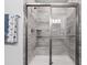 Shower featuring glass doors, tile surround, built-in shelves, and a rainfall shower head at 5876 Cremona Dr., Myrtle Beach, SC 29577