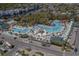 A stunning aerial view of a community pool area with multiple pools, waterslides, and lush landscaping at 6001-5610 S Kings Hwy., Myrtle Beach, SC 29575