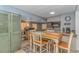 Dining area with a wooden table and chairs, complemented by a kitchen bar at 6001-5610 S Kings Hwy., Myrtle Beach, SC 29575
