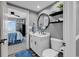 Bathroom with a white vanity, a round mirror, and open access to a bedroom at 603 S Ocean Blvd. # 1101, North Myrtle Beach, SC 29582