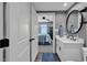 Bathroom with a white vanity, a round mirror, and access to a bedroom at 603 S Ocean Blvd. # 1101, North Myrtle Beach, SC 29582