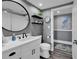 Bathroom featuring a toilet, vanity, mirror, shelving, and tasteful decorations on gray walls at 603 S Ocean Blvd. # 1101, North Myrtle Beach, SC 29582