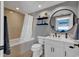 Neutral-toned bathroom featuring a vanity, toilet, bathtub with shower, and decorative accents at 603 S Ocean Blvd. # 1101, North Myrtle Beach, SC 29582