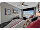 Comfortable bedroom featuring two beds, vibrant art, a ceiling fan, and a large window with great light at 603 S Ocean Blvd. # 1101, North Myrtle Beach, SC 29582