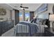 Stylish bedroom with a balcony, dark furniture, a ceiling fan, and beach artwork at 603 S Ocean Blvd. # 1101, North Myrtle Beach, SC 29582