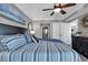 Comfortable bedroom featuring a king-size bed, beach artwork, and a ceiling fan at 603 S Ocean Blvd. # 1101, North Myrtle Beach, SC 29582