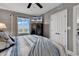 Comfortable bedroom features grey walls, a ceiling fan, large window, and stylish bedding at 603 S Ocean Blvd. # 1101, North Myrtle Beach, SC 29582