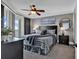 Well-lit bedroom with a ceiling fan, plush carpet, king-size bed, and balcony at 603 S Ocean Blvd. # 1101, North Myrtle Beach, SC 29582