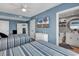 Well-decorated bedroom with blue walls, two beds, a TV, and an attached bathroom with a vanity at 603 S Ocean Blvd. # 1101, North Myrtle Beach, SC 29582