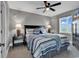 Comfortable bedroom with grey walls, ceiling fan, and striped bedding with decorative pillows at 603 S Ocean Blvd. # 1101, North Myrtle Beach, SC 29582