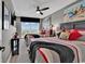Inviting bedroom with two beds, lively art, a ceiling fan, and a large window with shutter blinds at 603 S Ocean Blvd. # 1101, North Myrtle Beach, SC 29582
