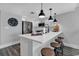 Open concept kitchen with modern white cabinetry, a kitchen island, and stylish bar stool seating at 603 S Ocean Blvd. # 1101, North Myrtle Beach, SC 29582