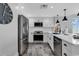 Modern kitchen features stainless steel appliances, white cabinets, and a kitchen island with pendant lights at 603 S Ocean Blvd. # 1101, North Myrtle Beach, SC 29582