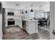 Modern kitchen features white cabinetry, stainless steel appliances, and an island with pendant lighting at 603 S Ocean Blvd. # 1101, North Myrtle Beach, SC 29582