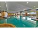 Large indoor pool with tile columns and lounge chairs under floor to ceiling windows at 603 S Ocean Blvd. # 1101, North Myrtle Beach, SC 29582