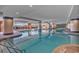 Large indoor pool with tile columns and lounge chairs under floor to ceiling windows at 603 S Ocean Blvd. # 1101, North Myrtle Beach, SC 29582