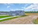 Aerial view of the house with blue roof and a large front yard at 604 Highway 747, Loris, SC 29569