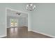 The dining room features hardwood floors, chandelier lighting, and French doors to the backyard at 604 Highway 747, Loris, SC 29569
