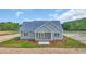 Well manicured lawn, white siding, and blue roof make this home a classic beauty at 604 Highway 747, Loris, SC 29569