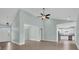 Open-concept living room with high ceilings, ceiling fan, and wood-look floors at 604 Highway 747, Loris, SC 29569