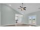Bright living room with ceiling fan and sliding doors to the backyard at 604 Highway 747, Loris, SC 29569