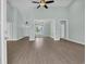 Open-concept living area showcasing wood-look floors and access to other rooms at 604 Highway 747, Loris, SC 29569
