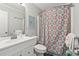 Cozy bathroom features a vanity, toilet, and shower with patterned curtain at 609 Hillside Dr. S # C-16, North Myrtle Beach, SC 29582