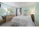 Bright bedroom with neutral carpet, a large bed, and decorative accents at 609 Hillside Dr. S # C-16, North Myrtle Beach, SC 29582