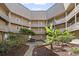 Charming building featuring a lush courtyard with mature plantings and multiple floors of balconies at 609 Hillside Dr. S # C-16, North Myrtle Beach, SC 29582