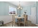 Charming dining area features a wooden table, coastal decor, and bright natural light at 609 Hillside Dr. S # C-16, North Myrtle Beach, SC 29582