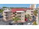 Scenic view of the condo community with a red roof, mature palm trees, and well maintained landscaping at 609 Hillside Dr. S # C-16, North Myrtle Beach, SC 29582