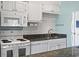 Well-equipped kitchen with white appliances, subway tile backsplash, and granite countertops at 609 Hillside Dr. S # C-16, North Myrtle Beach, SC 29582