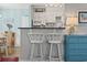 Charming kitchenette features white cabinets, a breakfast bar, and stylish coastal decor at 609 Hillside Dr. S # C-16, North Myrtle Beach, SC 29582