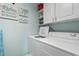 Well-equipped laundry room with white washer, dryer, and storage cabinets at 609 Hillside Dr. S # C-16, North Myrtle Beach, SC 29582