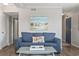 Comfortable living room features a blue sofa, a painting and coffee table, creating a welcoming atmosphere at 609 Hillside Dr. S # C-16, North Myrtle Beach, SC 29582