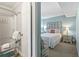 A view into the main bedroom with bright walls, comfortable bed, and ensuite bath at 609 Hillside Dr. S # C-16, North Myrtle Beach, SC 29582